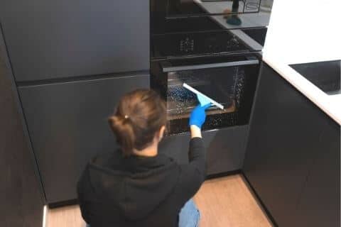 Clean microwave door with glass cleaner