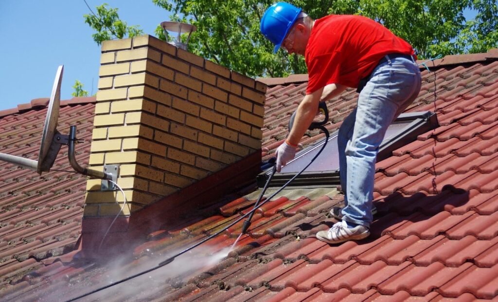 Cleaning the terracotta roof tiles.