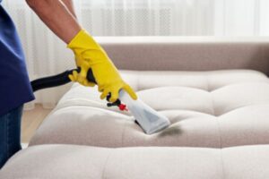 Clean a fabric sofa with a steamer or couch cleaner 